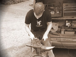 Horse shoe making on anvil